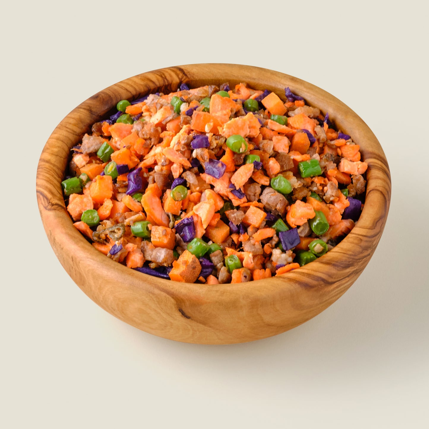 Organic grain-free lamb and salmon dog food in a rustic wooden bowl, made with fresh organic ingredients for a nutritious and balanced diet.